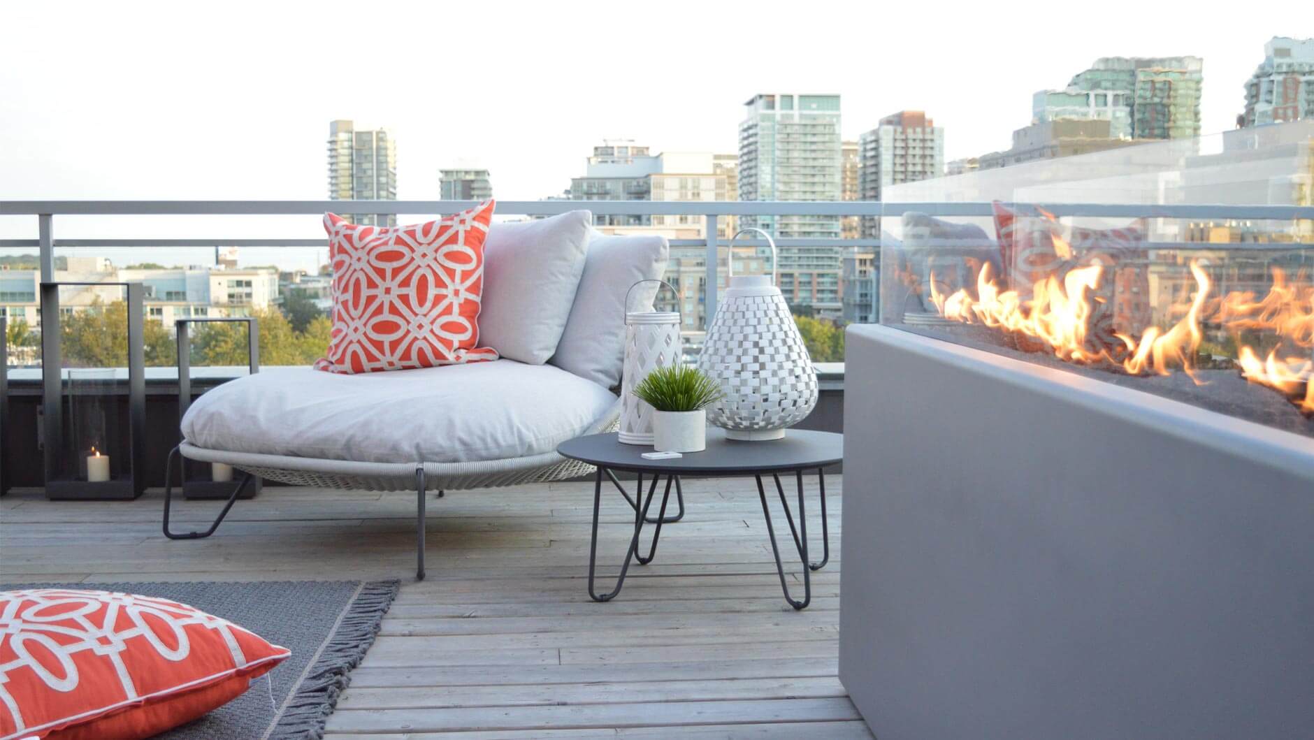 Balcony patio with fire to the right and a chair with mini table in front