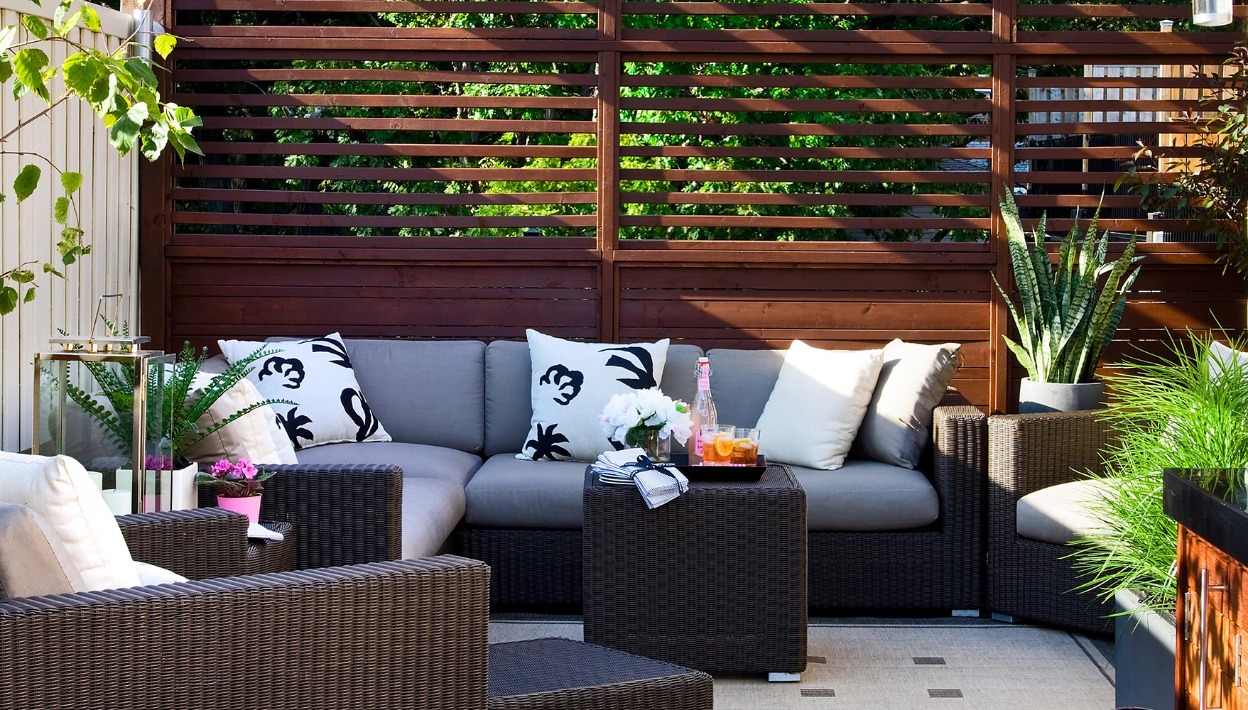 Fenced off area with couch and beverages on a centerpiece