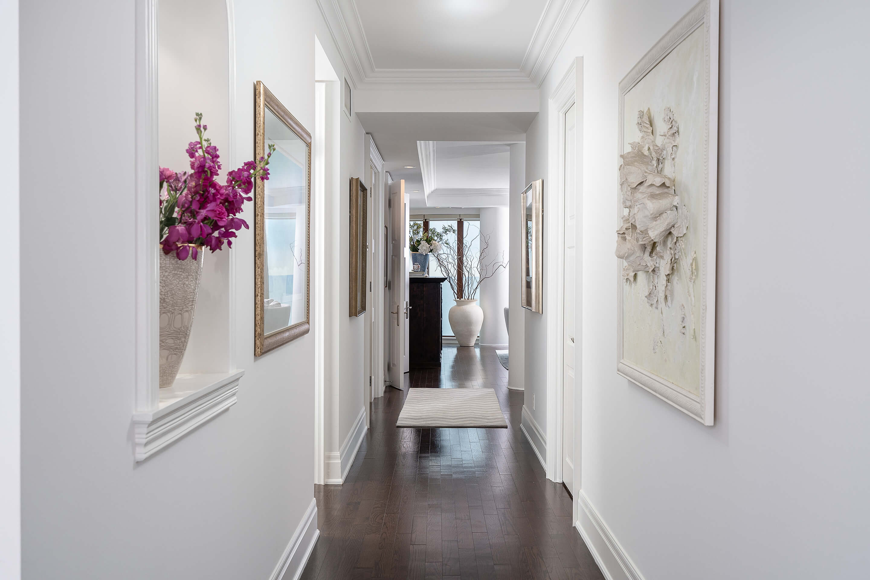 Hallway with white walls and frames on walls