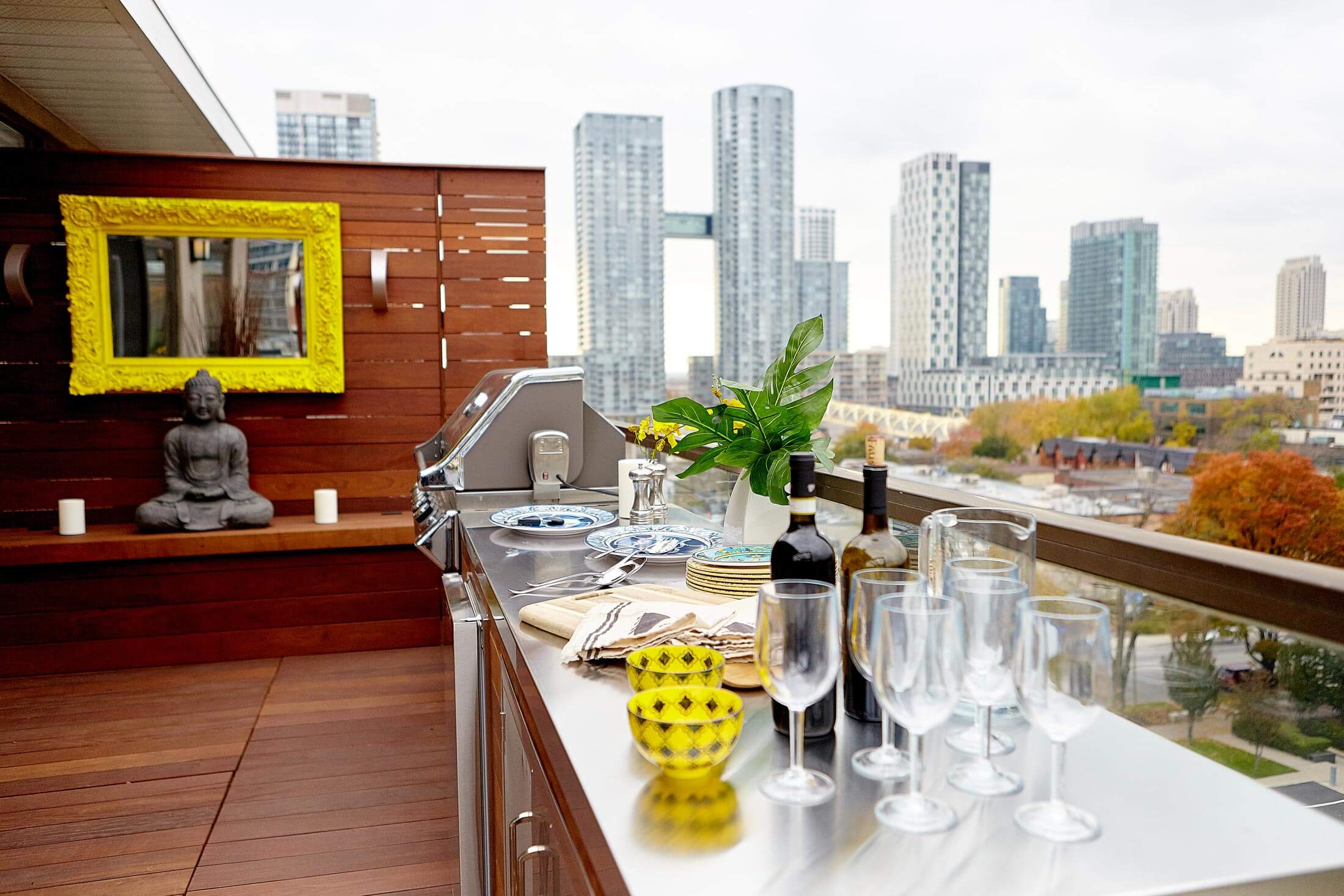 Balcony with dining area. Buildings visible in background