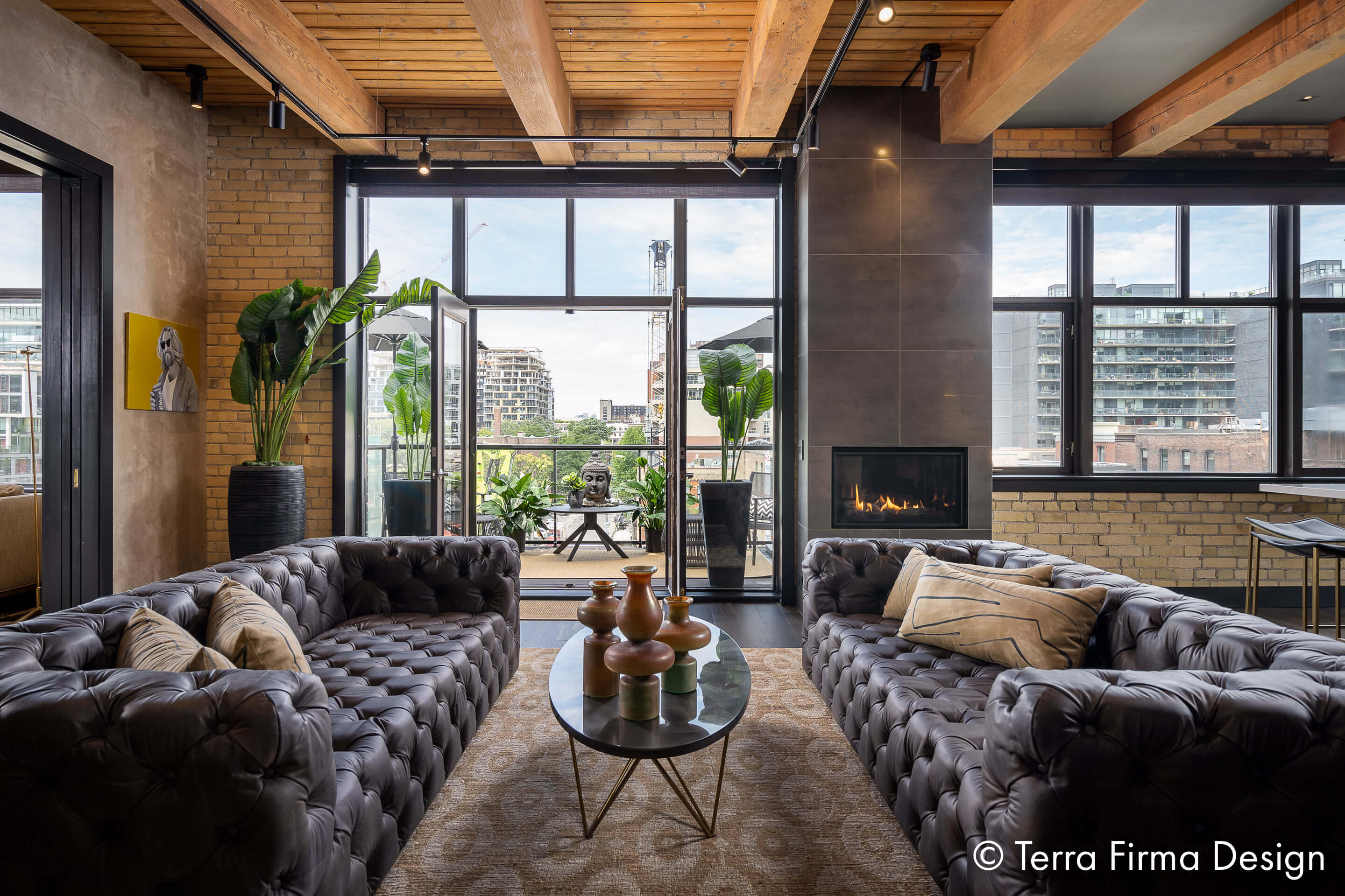 Inside of a loft with furniture and a fireplace